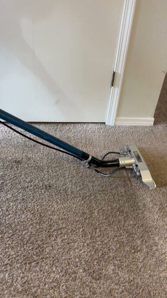A professional carpet cleaning wand in action on a residential carpet by Tailor Maid Carpet Cleaning in Colorado Springs, CO.