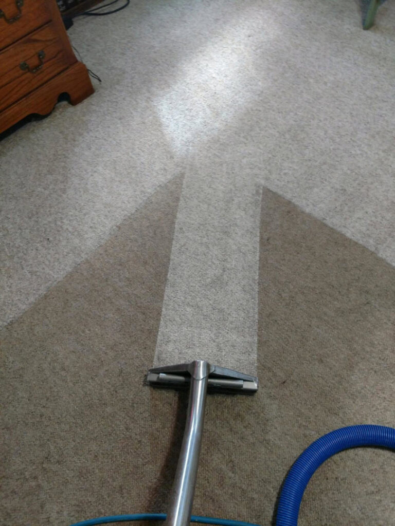 A professional carpet cleaning wand in action, showing a clean path on a carpet by Zerorez Wichita in Wichita, KS.