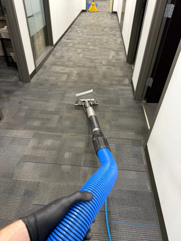 A carpet cleaning wand being used to clean a commercial hallway carpet by Great Day Carpet & Tile Cleaning LLC Desoto in Olive Branch, MS.