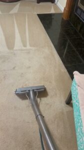 A carpet cleaning wand being used to clean a light-colored carpet by Jones Carpet Care LLC in Huntsville, AL.