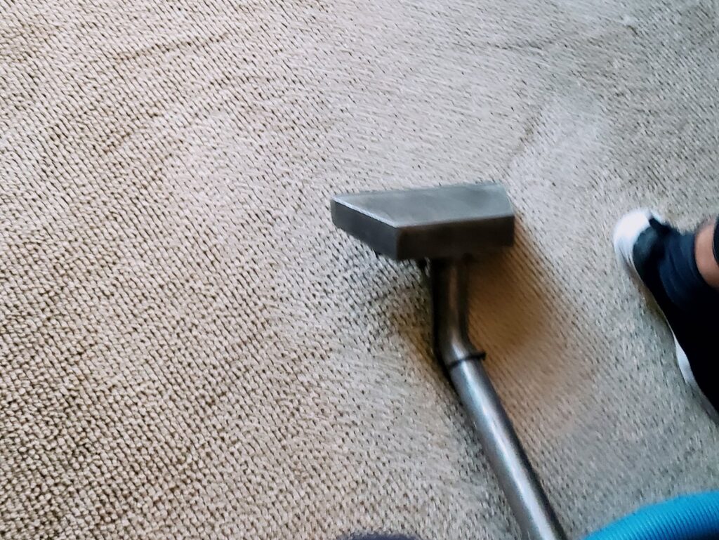 A carpet cleaning wand in action on light-colored carpet by Columbia Flooring Group in Troutdale, OR