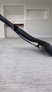 A carpet cleaning wand in action, cleaning a light-colored carpet at Cosmo Carpet Cleaning in Princeton, NJ.