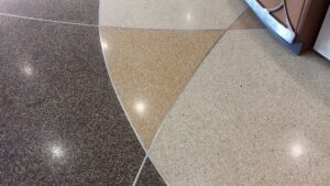 A close-up of a carpet cleaning wand extracting dirt and water from a carpet by Jason Lostetter Carpet Cleaning in New Glarus, WI.