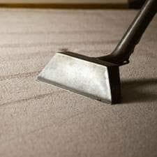 A professional carpet cleaning wand in action, cleaning a carpet at Servicemaxx in Indianapolis, IN.