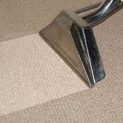 A carpet cleaning wand demonstrating a clean line on a carpet by Vibro-Steam of Utah in Ogden, UT.