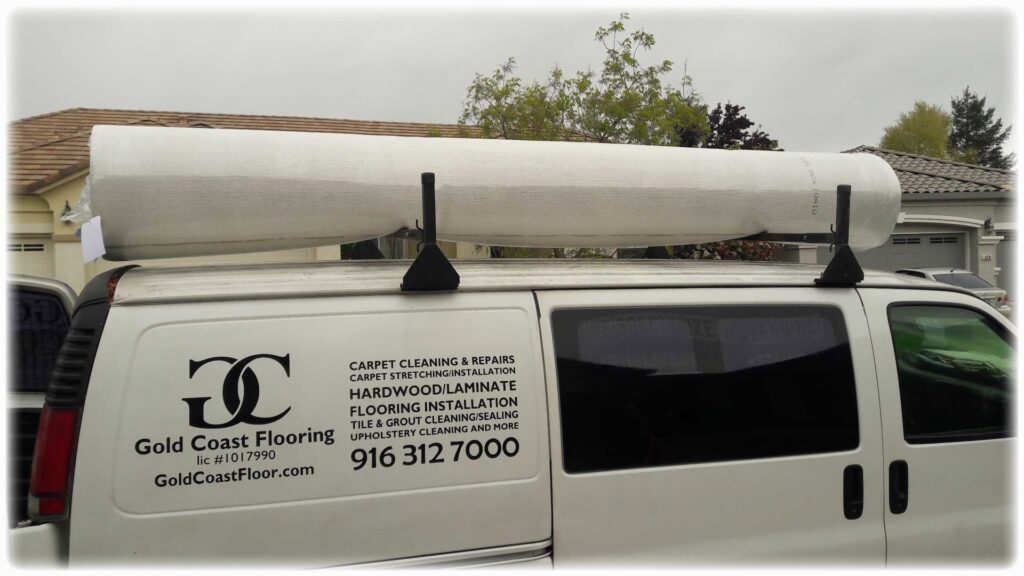 GoldCoast Carpet & Tile Care van carrying a roll of carpet for installation or repair in Sacramento, CA.