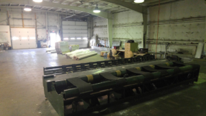 A large carpet cutting and binding machine in the warehouse of Home Carpet Distributors in Columbus, OH.