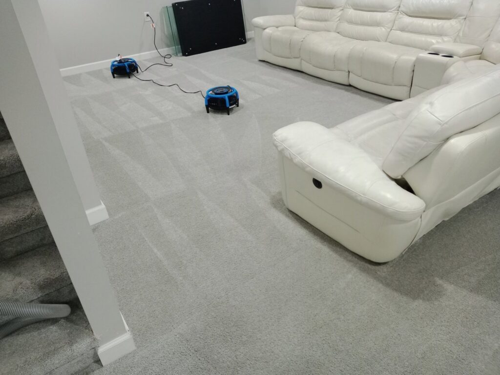 Two carpet drying fans in a living room with freshly cleaned carpet showing cleaning lines by Proper Carpet Cleaning in Aurora, IL.