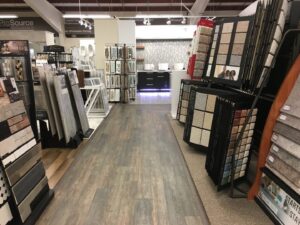 An aisle in the Prosource of Erie showroom displaying carpet and other flooring samples in Erie, PA.