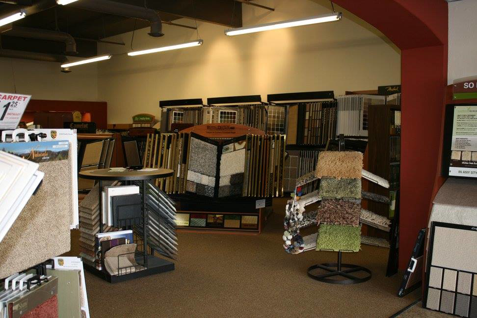 A well-lit showroom displaying various carpet and flooring options at Discount Carpet Brokers in Scottsdale, AZ