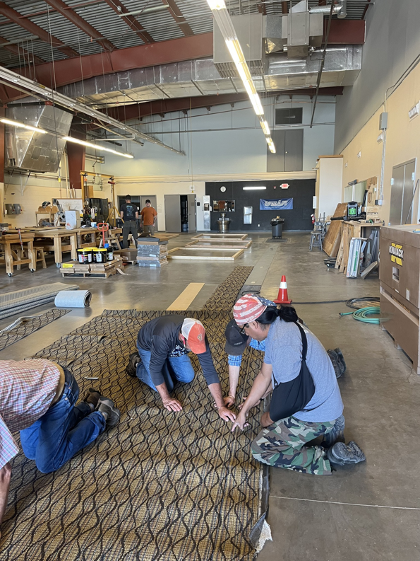 A crew of carpet contractors installing new carpet flooring at a job site for Floors & More Abbey Flooring in Great Falls, MT.