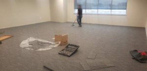 Carpet installation in progress in a large commercial space by Experience Carpet Installers in Dallas, TX.