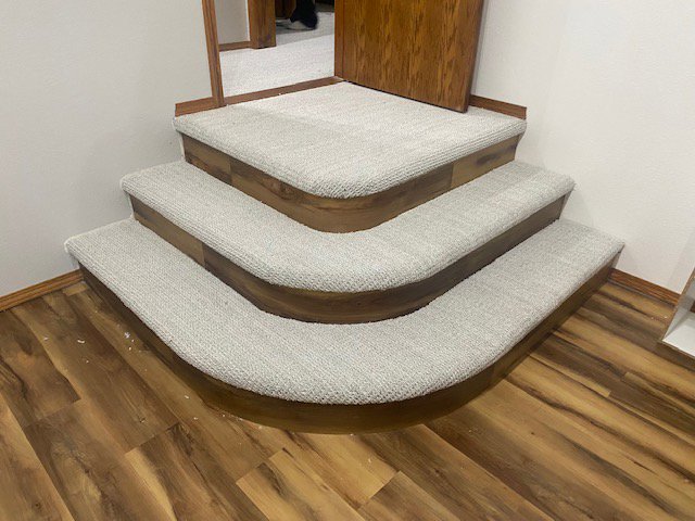 Custom carpet installation on curved stairs with wooden risers by Fairbanks Carpets Plus in Fairbanks, AK
