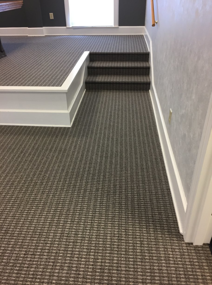 Professional carpet installation on stairs and a raised platform, completed by Tony Trujillo Flooring Sales & Installation in Franklin, TN.