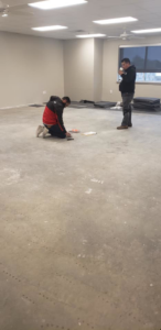 Team members preparing a room for new carpet installation by Experience Carpet Installers in Dallas, TX.