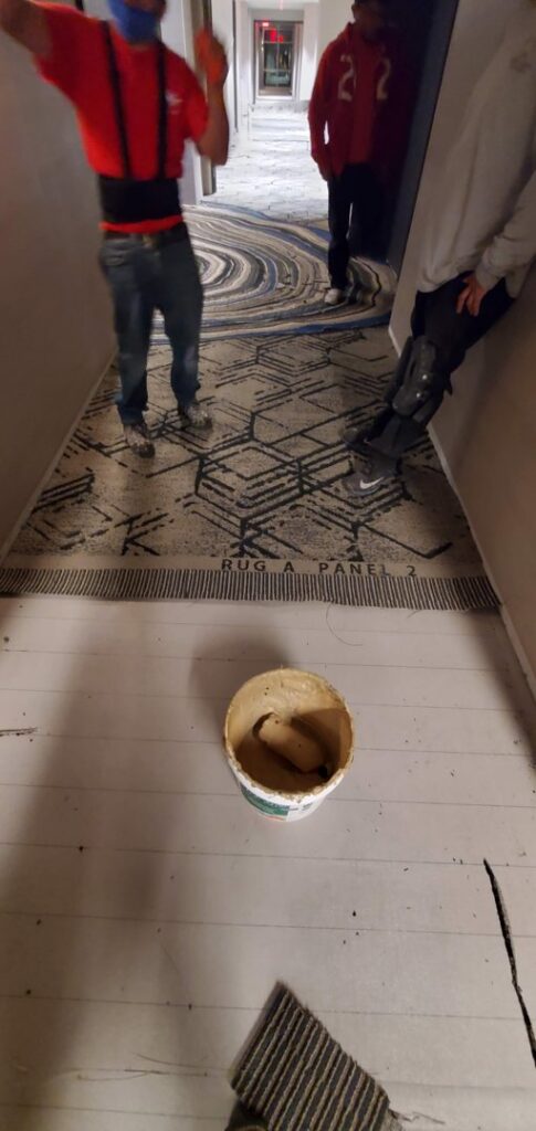 Carpet installation in progress in a commercial hallway by Az Budget Flooring LLC in Tucson, AZ