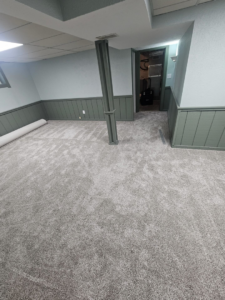 A completed carpet installation project in a room with a visible carpet roll by Carpets Mostly in Indianapolis, IN