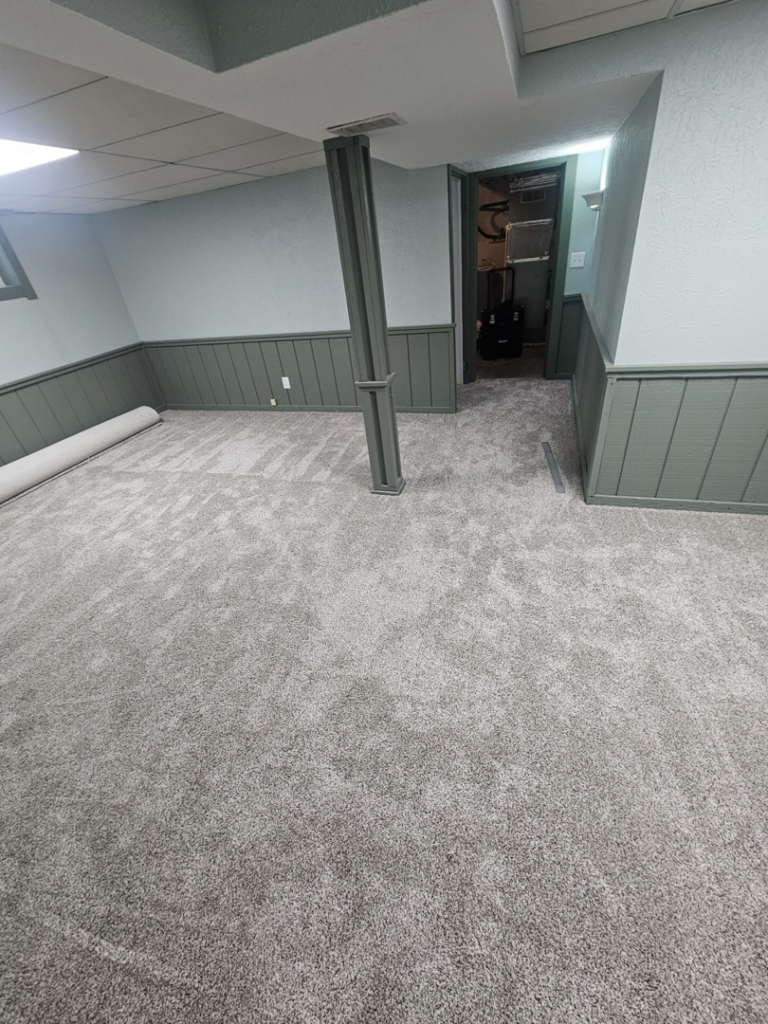 A completed carpet installation project in a room with a visible carpet roll by Carpets Mostly in Indianapolis, IN