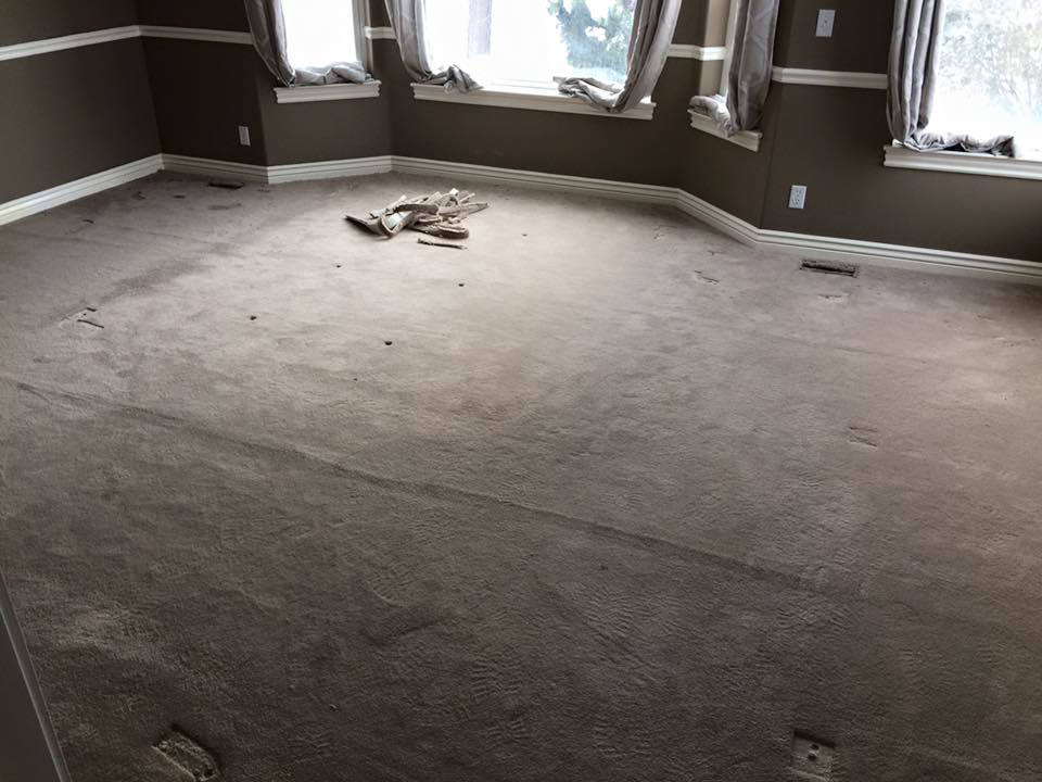 Carpet installation or repair in progress in a large room, showing the work of Essential Carpet Repair in Salt Lake City, UT.
