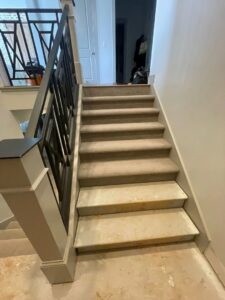 Carpet installation in progress on stairs by Eige General Services in Orem, UT