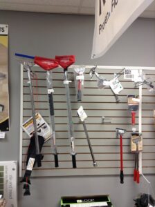 A wall display of professional carpet installation tools at East Bay Supply Co. in Birmingham, AL.
