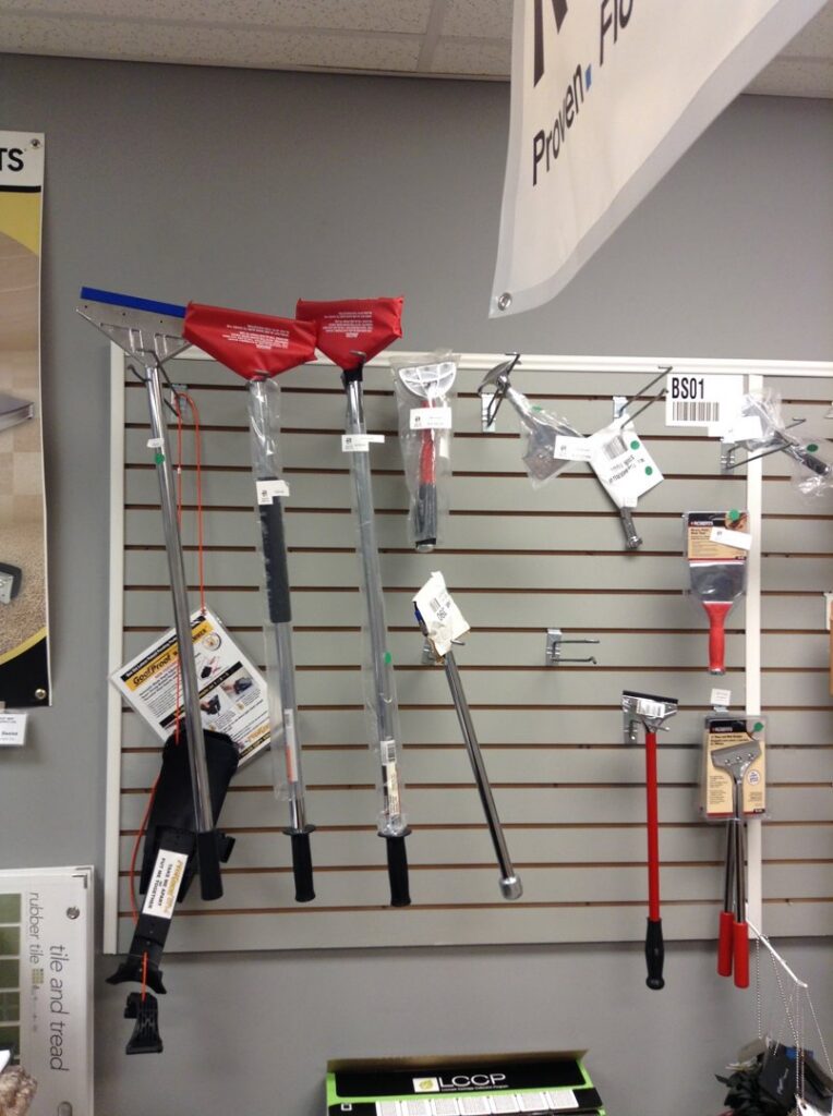 A wall display of professional carpet installation tools at East Bay Supply Co. in Birmingham, AL.