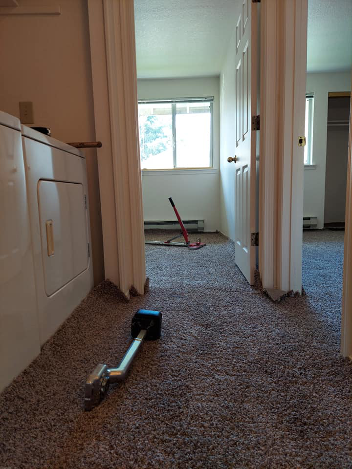 Carpet installation in progress with tools in a hallway by Columbia Flooring Group in Troutdale, OR