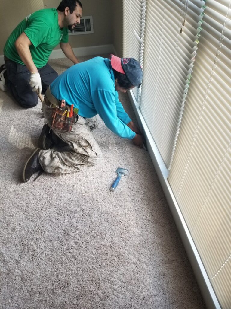 Two professional carpet installers working on a new carpet installation by Right & Clean Atlanta 24-7 Carpet Cleaning in Atlanta, GA.