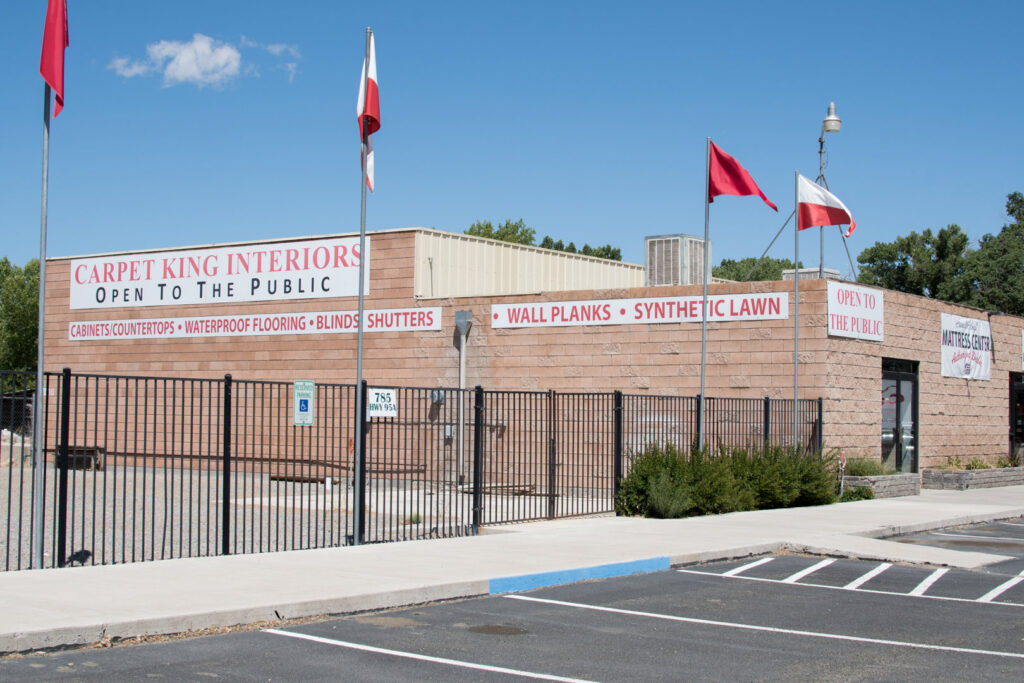 The exterior of the Carpet King Interiors / Abbey Carpet & Floor building in Fernley, NV, showcasing various services offered.