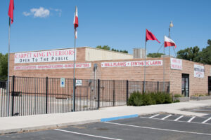 The exterior of the Carpet King Interiors / Abbey Carpet & Floor building in Fernley, NV, showcasing various services offered.