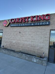 The storefront of Carpet King Interiors / Abbey Carpet & Floor in Fernley, NV, featuring the business sign.