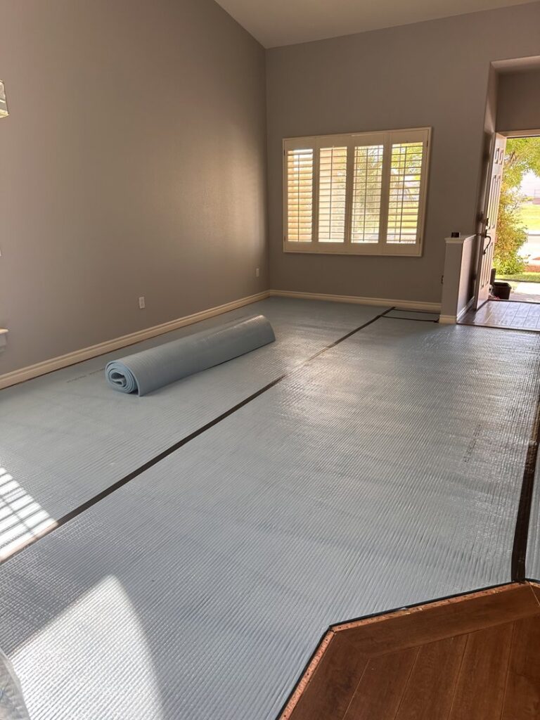 Carpet padding and underlayment laid out in a room, ready for carpet installation by Floors by Aldaba LLC in North Las Vegas, NV.
