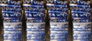 Stacks of blue carpet padding rolls in a warehouse, ready for installation by GC Flooring - Houston, TX