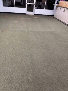 A yellow carpet repair tool next to a damaged carpet edge, indicating carpet repair work by B's Carpet Cleaning in Saint George, UT.