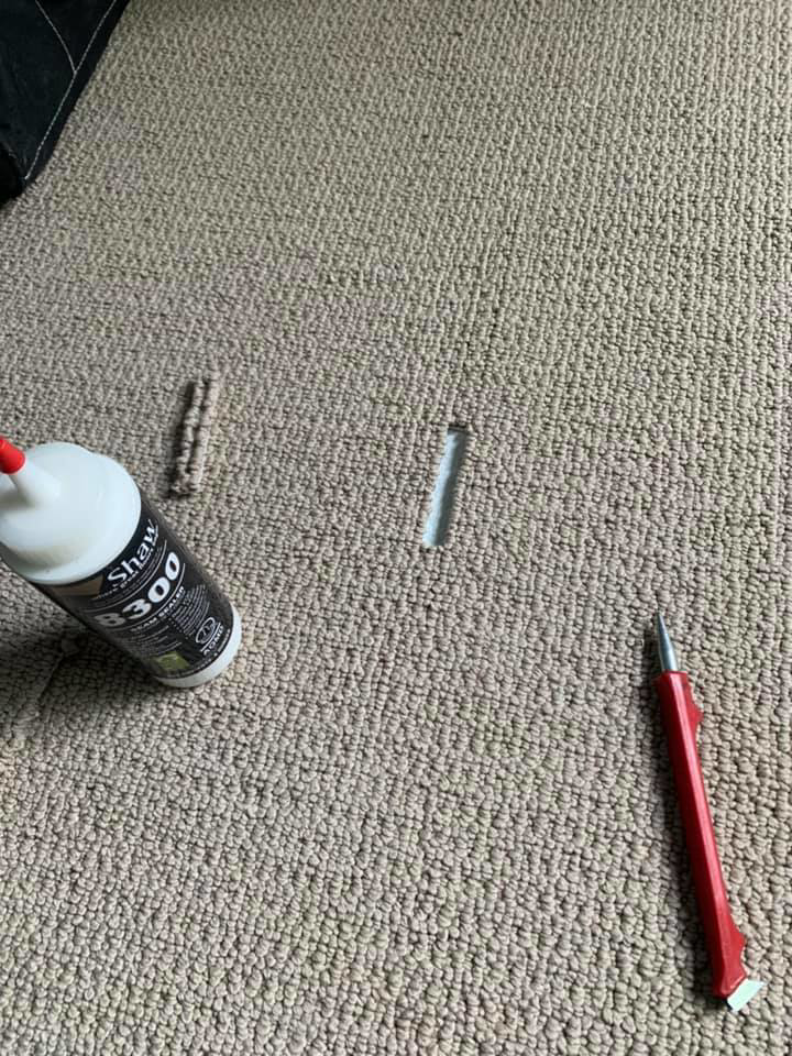 Close-up of carpet repair tools and adhesive on beige carpet by Ayala's Carpet Inc in Chicago, IL.