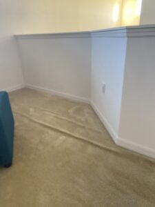 A carpeted room with significant ripples, highlighting the need for stretching service from Mr. Carpet Cleaning Orlando, FL.