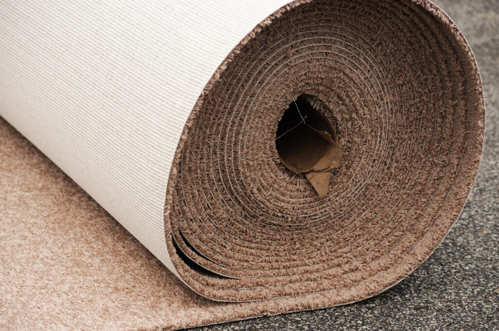 A large roll of new carpet ready for installation by Rebecca's Flooring Design Co. in Londonderry, NH.