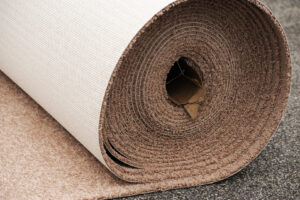 A large roll of new carpet ready for installation by Rebecca's Flooring Design Co. in Londonderry, NH.