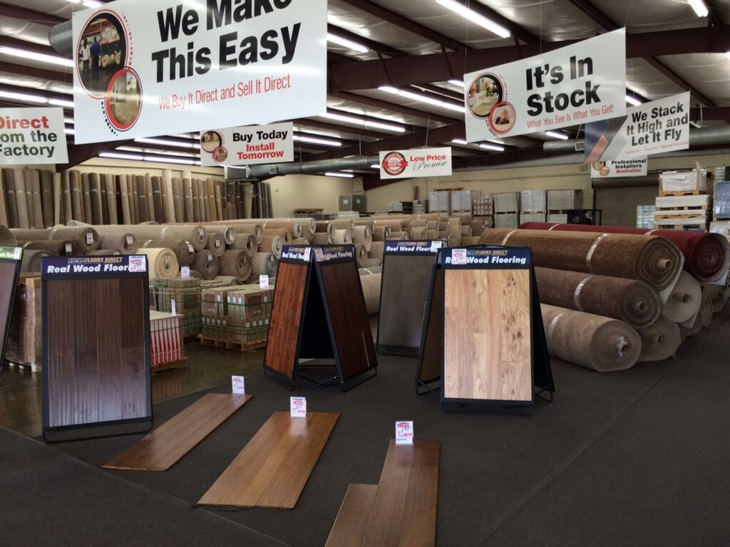 Rolls of carpet and various flooring samples displayed in the showroom at Georgia Floors Direct in Tallahassee, FL