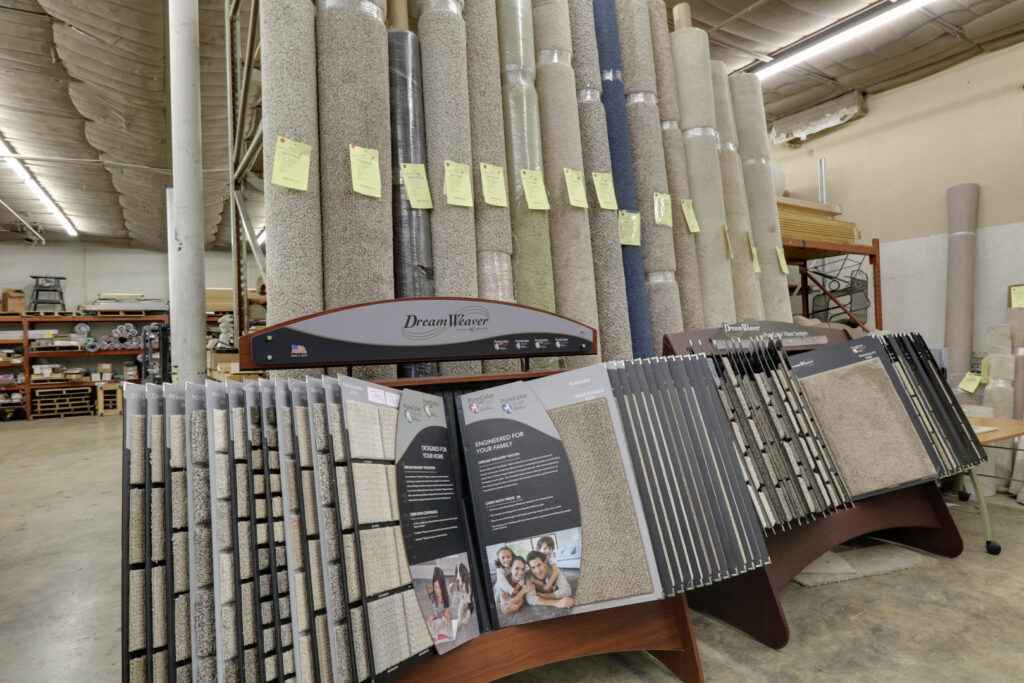 Large rolls of various carpets and carpet sample displays at Floor Depot San Antonio, TX