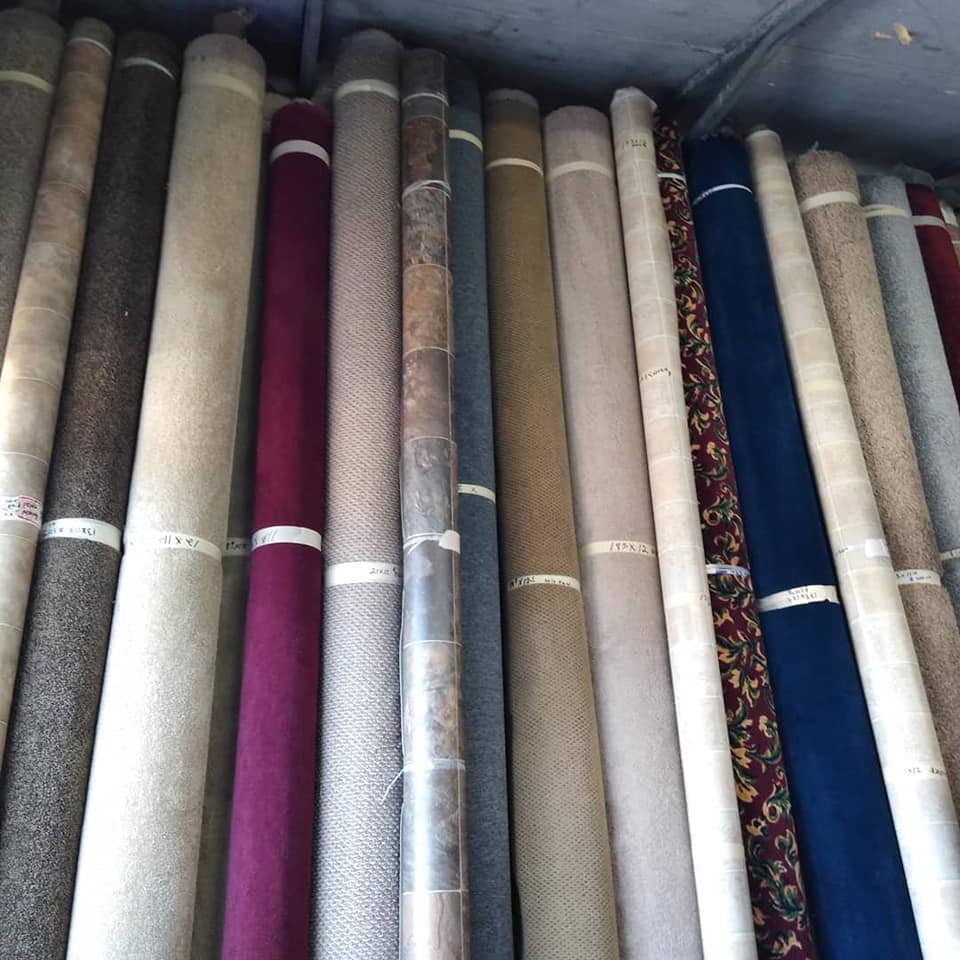 A selection of carpet rolls in various colors and textures, part of the inventory at AFAB Carpets in Tampa, FL.