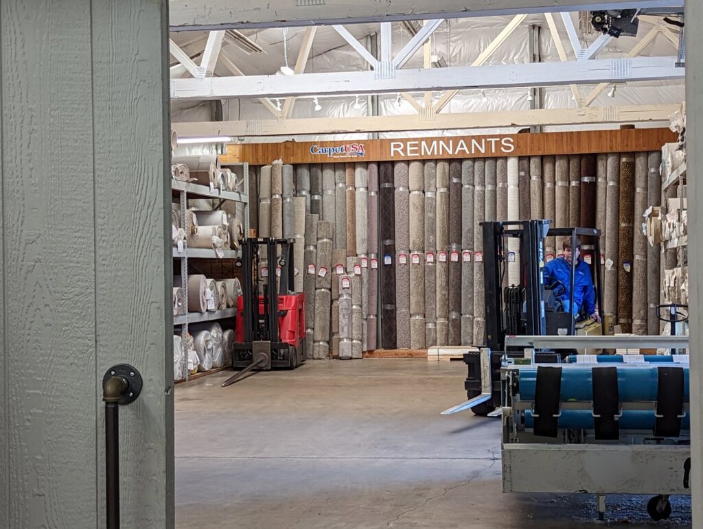 Large rolls of carpet stored in a warehouse at Carpet USA in Vancouver, WA, ready for contractor jobs.