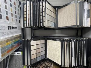 Close-up of various carpet and rug samples displayed in the showroom at Rugs By Design in Castleton, IN
