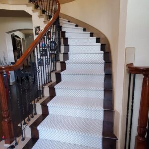 A beautifully installed carpet runner on a curved staircase by All Bay Hardwood Floors in San Jose, CA.