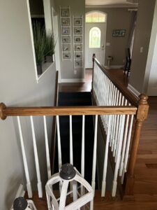 A dark carpet runner installed on a residential staircase by Mastercraft Wood Flooring in Loudon, TN