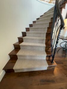 A beautifully installed carpet runner on a hardwood staircase by Universal Flooring in Idaho Falls, ID.