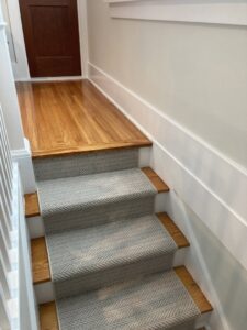 Newly installed carpet runner on a wooden staircase by Bryer Carpet & Blinds in Lincoln, NE