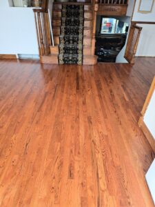 A dark patterned carpet runner professionally installed on wooden stairs by Footprints Floors Salt Lake City in Plain City, UT.