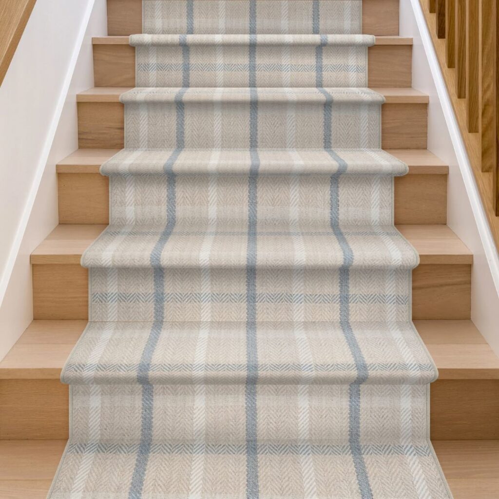 A stylish carpet runner installed on wooden stairs by Morency Flooring, a carpet contractor in New Bedford, MA.