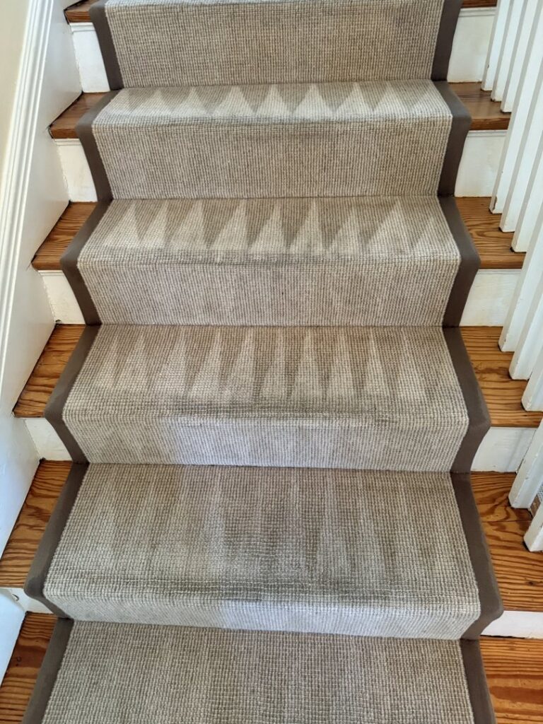 Carpeted stairs with a runner showing cleaning lines after a professional service by Hydro Clean in Baltimore, MD.